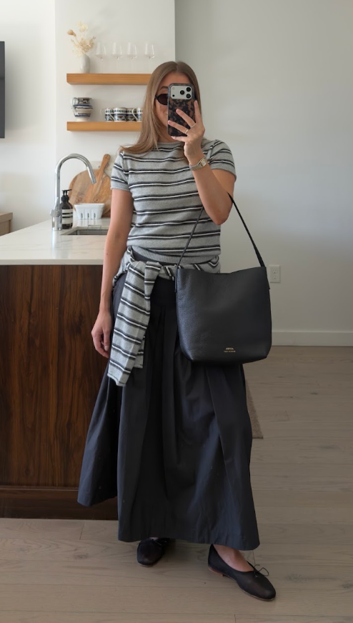 ALVEA black bucket bag styled with a striped top and black skirt