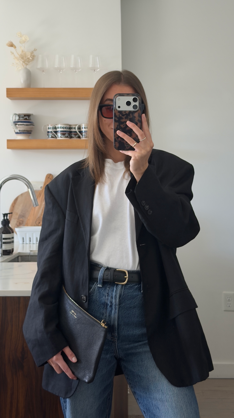 Black ALVEA leather pouch and belt styled with a black blazer and jeans