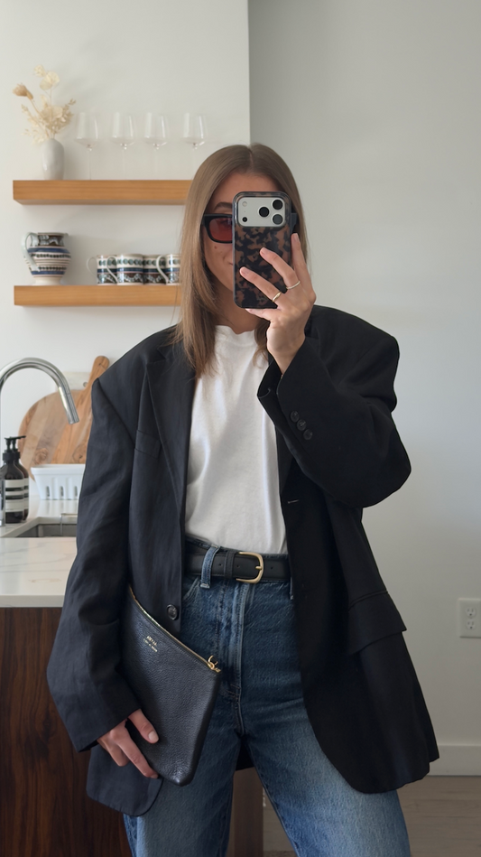 Black ALVEA leather pouch and belt styled with a black blazer and jeans